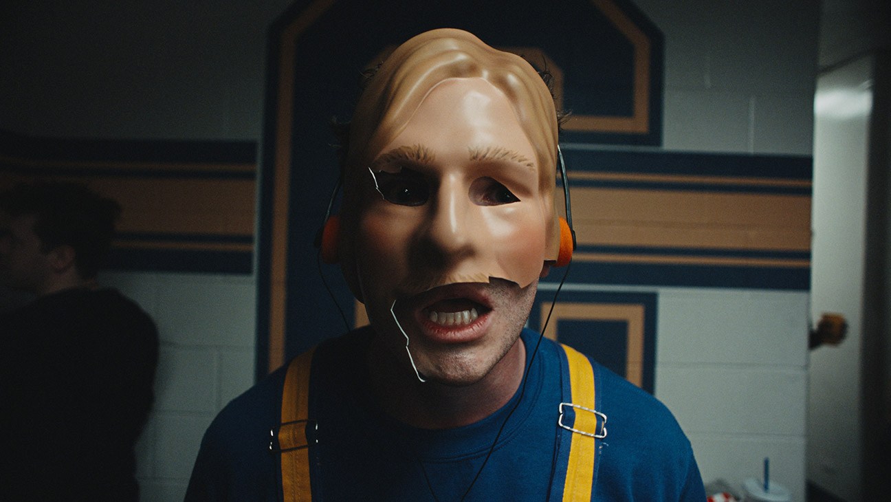 Official Disney/Hulu first-look still from Chad Powers Season 2: Glen Powell as Chad with a cracked prosthetic mask in the locker room. Photo: Disney / Daniel Delgado Jr.