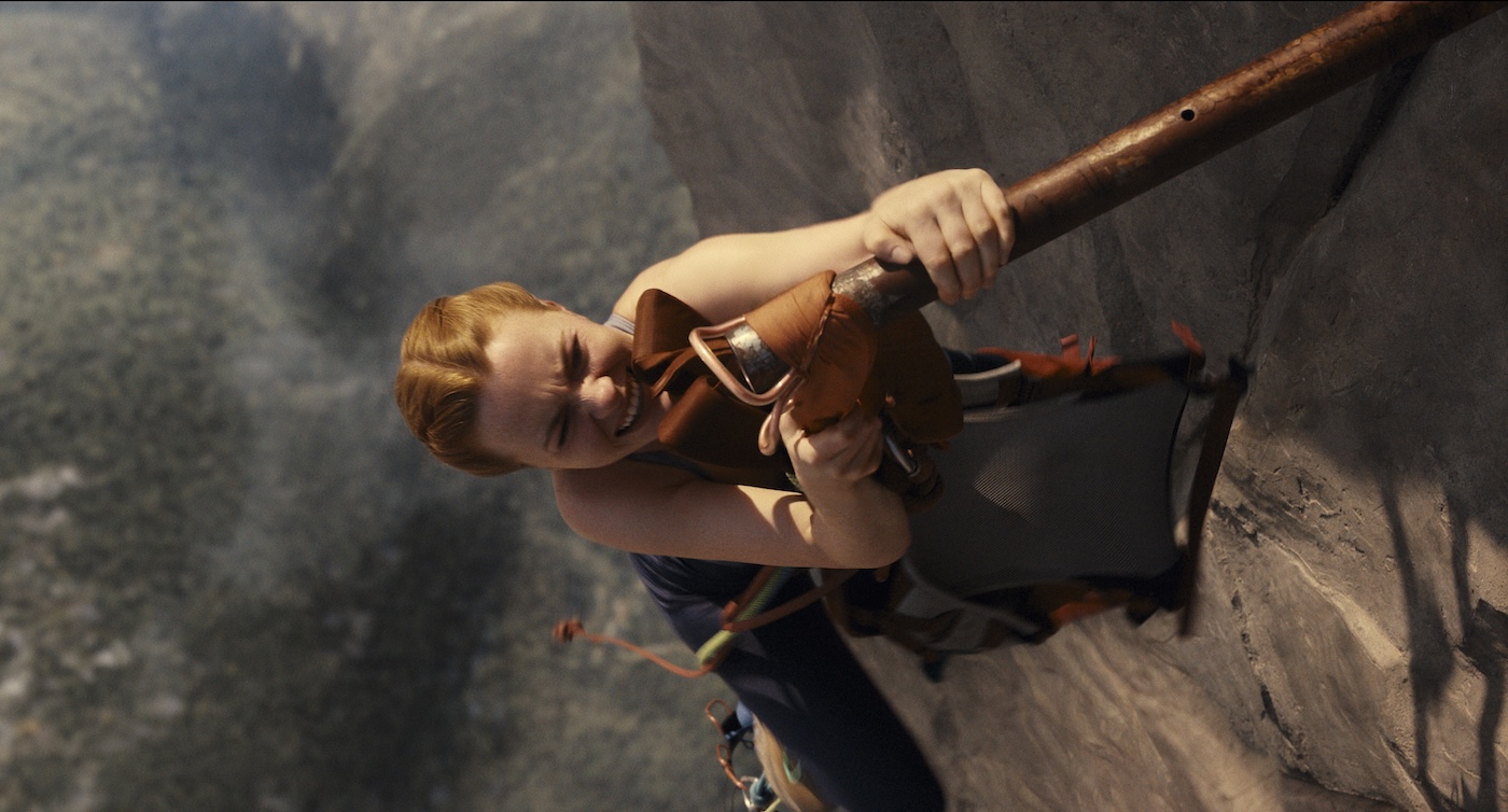 Official Lionsgate still from Fall 2: Deadpoint. Harriet Slater as Jax hangs from a cliffside rung above the Mount Kwan drop. Courtesy of Lionsgate.