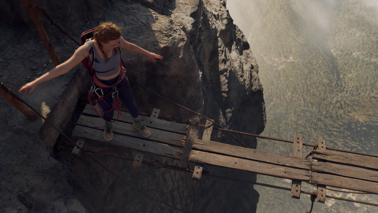 Official Lionsgate still from Fall 2: Deadpoint. Harriet Slater as Jax balances above the Mount Kwan valley on the plank walk. Courtesy of Lionsgate.