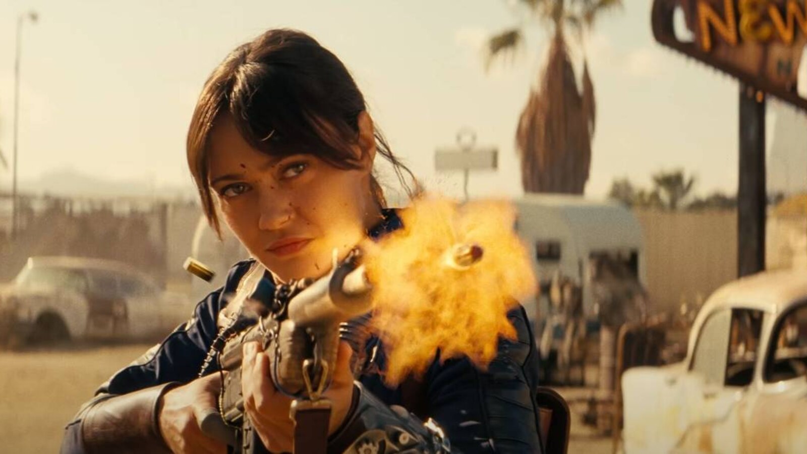 Official Prime Video Fallout still of Ella Purnell as Lucy MacLean firing through the wasteland in her Vault 33 suit. The series imagery is part of Stern Pinball's reveal campaign. Courtesy of Prime Video.