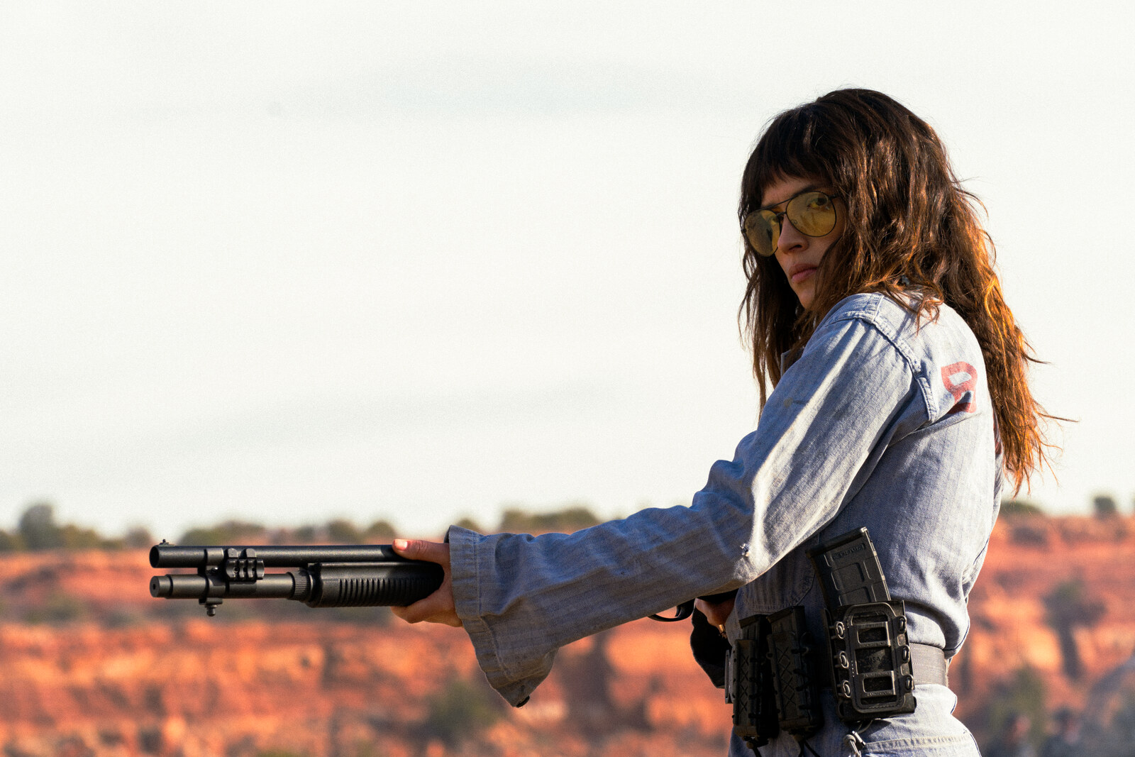 Official A24 still of Adria Arjona as Celeste in Onslaught, desert light and tactical readiness. Photo: Richard Foreman / A24.