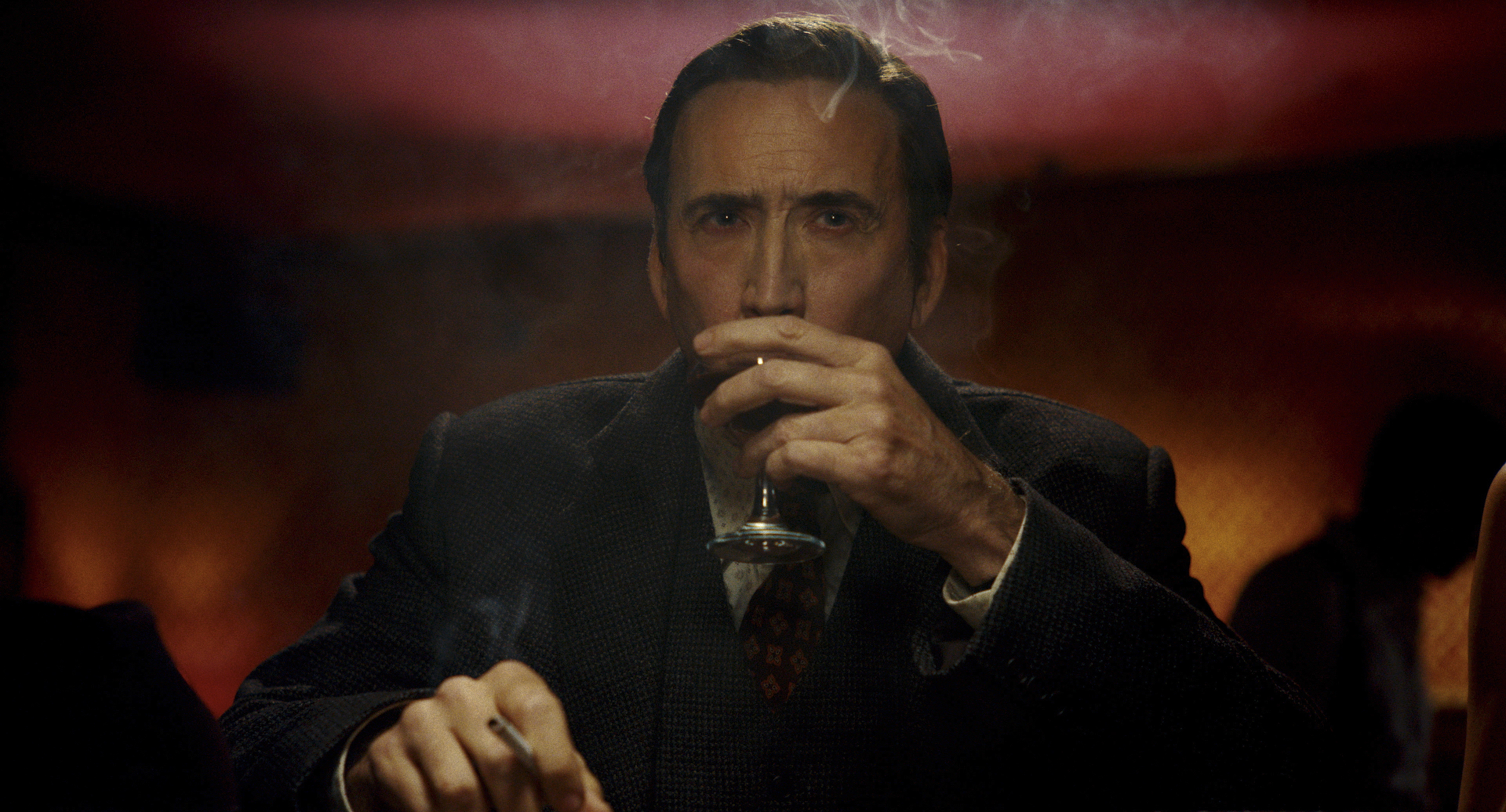 Official Prime Video still: Nicolas Cage as Ben Reilly in Spider-Noir, cigarette and glass in a low-lit lounge. Aaron Epstein / Prime Video.