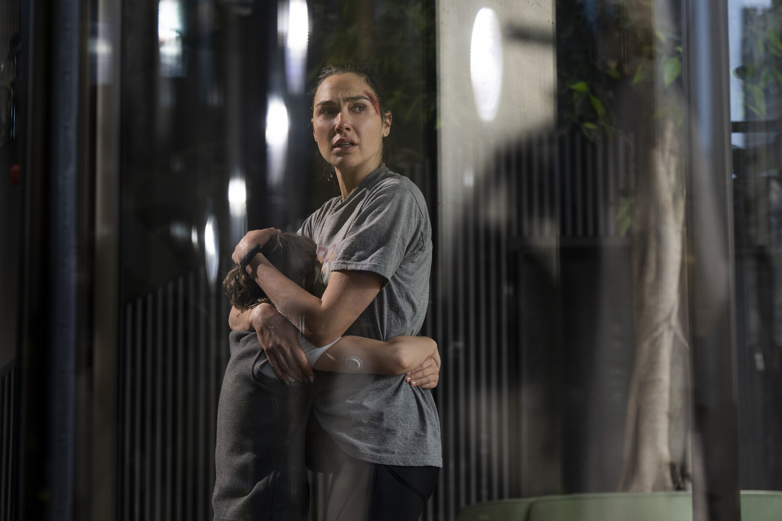 Official Amazon MGM / Prime Video still from The Runner: Gal Gadot as Maia Marten holding her son Noah. Courtesy of Prime Video / Amazon MGM Studios.