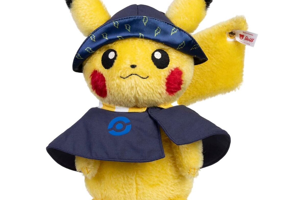 The Steiff 2026 Pokémon World Championships Exclusive Pikachu, first accessorized edition, navy cape and lightning visor, button-in-ear tag visible. Pokémon Center product photo via IGN exclusive.